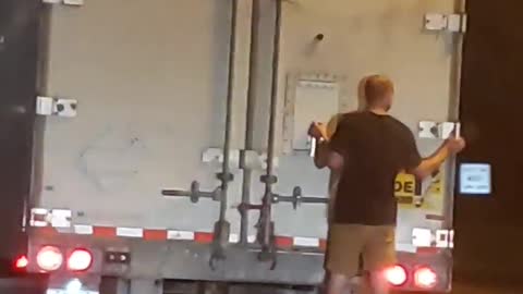 Man Clings to the Back of 18-Wheeler on Freeway