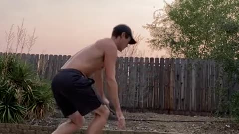 Guy Wears Clothes While Balancing Himself on Slack Line