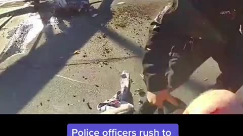 Police officers rush to save a pilot who crashed, just seconds before a train passes