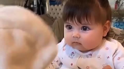 This baby is angry at his doll while his mother is confused