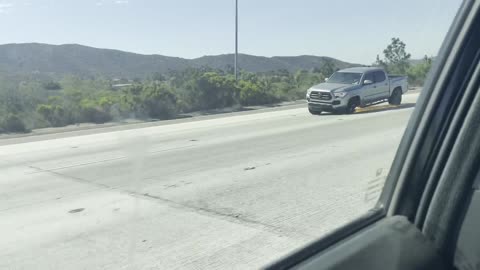 Truck with Three Wheels Hauls Down Highway