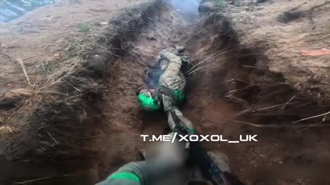 Ukrainian soldiers defend their trench while trying to save the life of an injured ukrainian soldier