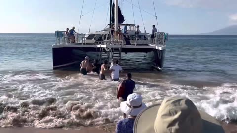 Wet Beach Loading for Kai Kanani Sunset Sail in Makena, Maui (in moderate surf)