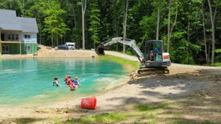 Man Uses Excavator to Create Makeshift Water Park for Kids