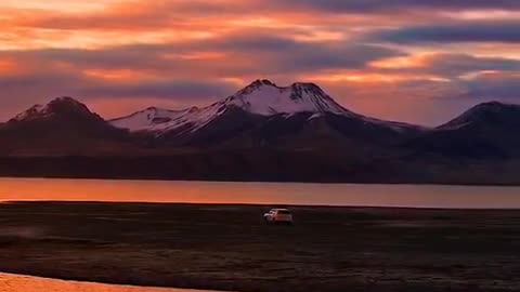 A mountain, a river, a moving car