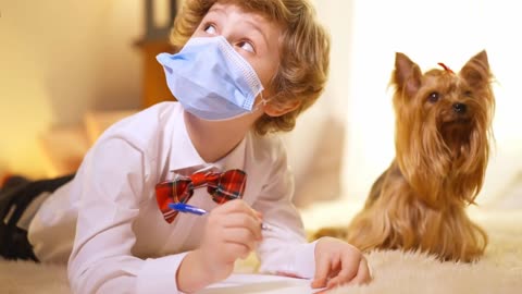 Portrait of cute Caucasian child wishing miracle on New Year. Pretty dog at background