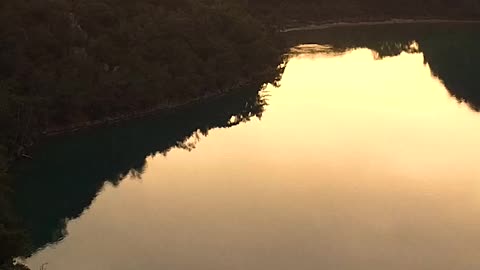 A Speedboat in a Lake at Sunset