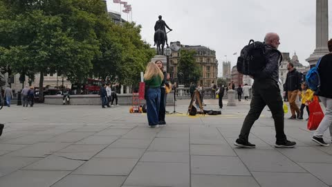 Street performer singing Heads under water Travalger square Sep 2022