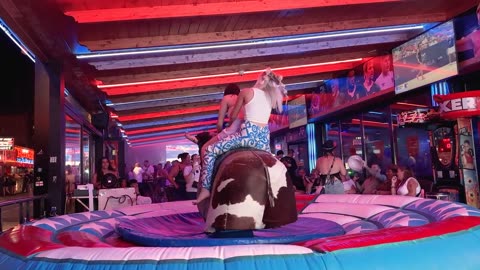 🔥 Dress-Wearing Beauties Tackle Benidorm Bull_ Mechanical Bull Riding