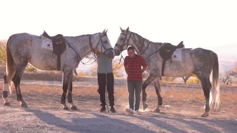 Goreme,Turkey. Two men preparing horses for ride