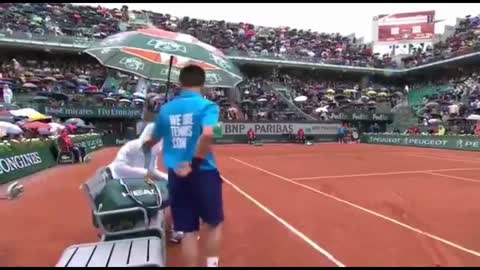 Novak Djokovic calls Ball boy from rain, holds an umbrella. for him " Act of Kindness