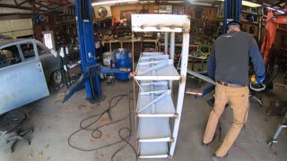 Welding some scrap metal into shelves