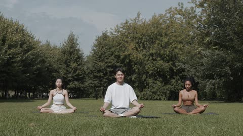 Three People Meditating Outdoors