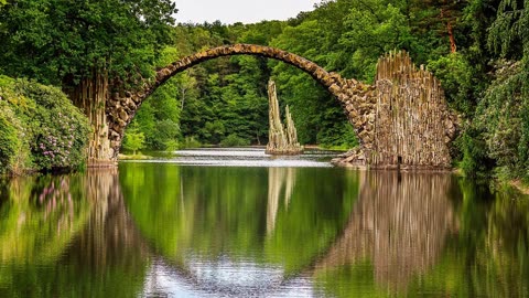 The sound of birds chirping can be heard while water flows.