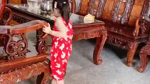 Cute baby cleaning the house