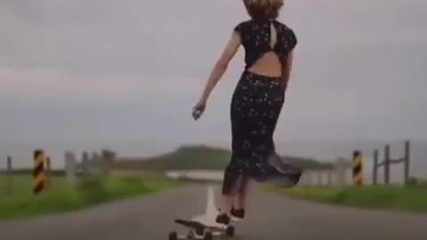 chick dances while she carves on her long board.