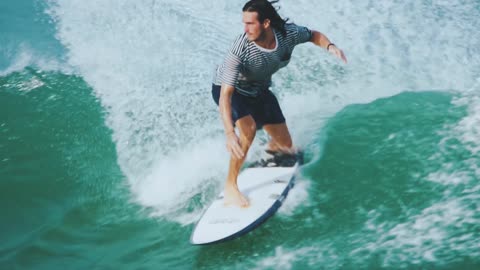 A Male Surfer Riding Skillfully The Sea Waves