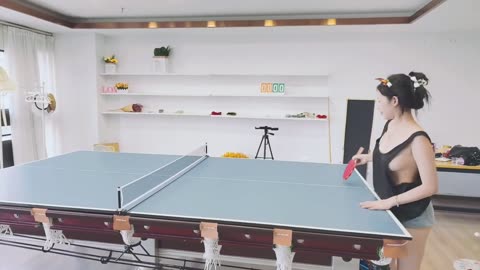 Sexy asia girl wearing black Low-cut vest playing table tennis