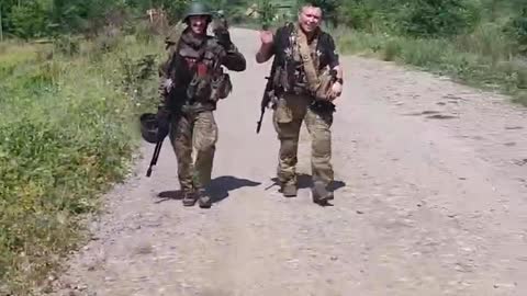 Two Ukrainian conscripts high tail it out of Lisichansk yesterday.