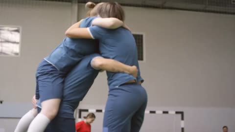 videoblocks happy female soccer player giving piggyback ride embracing and huddling with team while