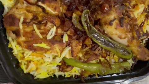 Kabsa rice with vegetables and chicken on plate