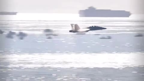 Amazing slo-mo tracking shot of a vapor cone forming around a transonic F-18.