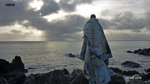 Artist creates his work floating in the sea