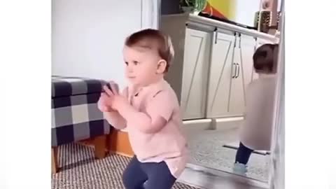 Cute baby funny dance in front mirror