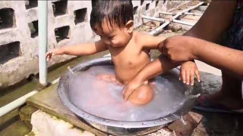 Cute baby taking bath by mother love with full of joy