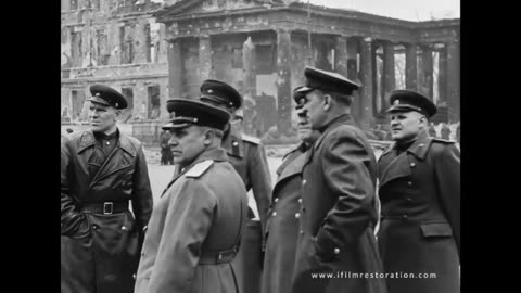 Zhukov and other high ranks of the Red Army walk through the ruins of the city.