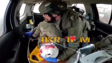 Ukrainians evacuate a wounded Polish mercenary.