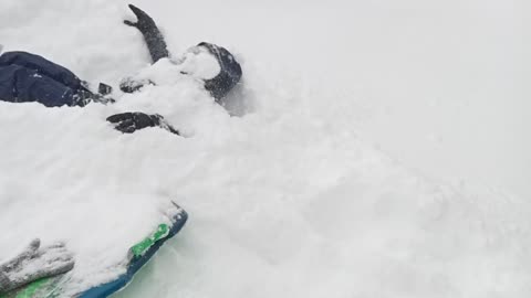 Boy gets covered in snow