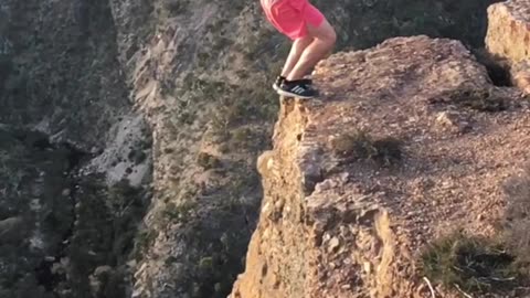 Edge of Adrenaline: Daring Backflip on the Cliff’s Precipice! 🌀🏞️