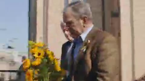 Former Presidents Bill Clinton And George W. Bush Lay Flowers At A Ukrainian Church