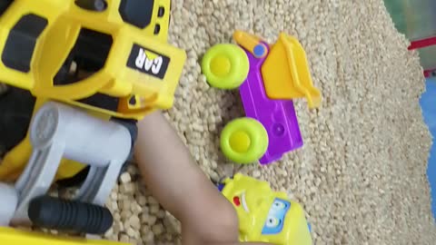 Smart toddler playing with material excavator at supermarket - part 3