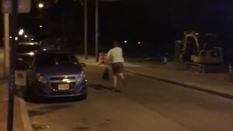 Guy skateboards green shirt light on helmet