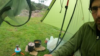 Making a brew in the tent by a stream