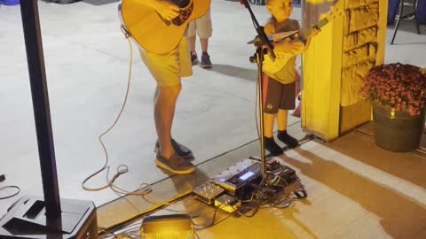 A boy and a man with their guitars