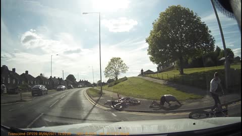 Biker Collides with Back of Car