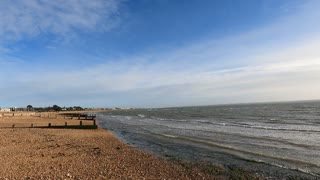 At beach on a sunny and windy day.