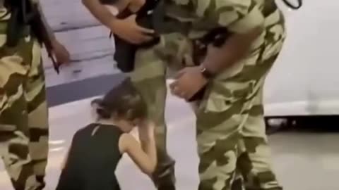 Young Girl Touches a Soldier's Feet: A Beautiful Gesture of Gratitude 👧