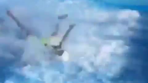 Kid highlight green shorts yellow boogie board wave machine wipe out fail