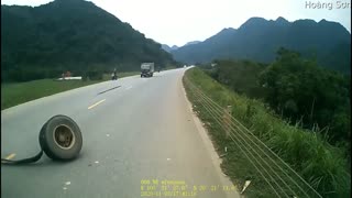 Truck Loses Tire on Curving Road