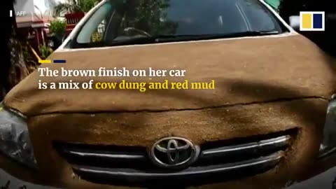 Indian pajeet woman covers her car in cow dung to avoid scorching heat