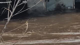 Refrigerator stuck under a bridge