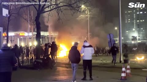 Riots erupt in The Hague with protesters torching cars and clashing with cops