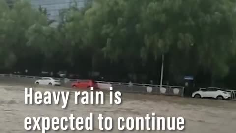 Passengers become trapped on flooded underground train after torrential rain in China