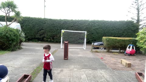 Little Boy Shoots a Ball Mid Air Back