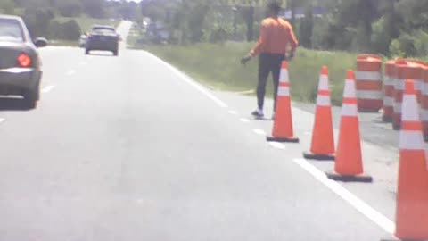 Maniac flings cone into traffic