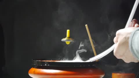 Levitating Top In A Smoke Bubble